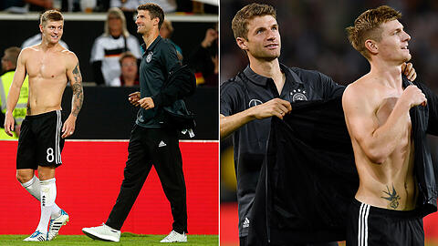 Hilfsbereit, der Herr Müller: Nach dem WM-Qualifikationsspiel der DFB-Elf gegen Norwegen (6:0) gibt Thomas Müller seinem fröstelnden Teamkollegen und früheren Bayern-Profi Toni Kroos seine Trainingsjacke und hält ihm dann auch noch die Ärmel.