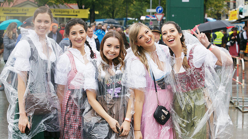 Schon etliche Stunden vor Anstich strömen die Wiesnbesucher auf das Festgelände. Die Bilder zum verregneten Wiesn-Auftakt am Samstag zum Durchklicken.