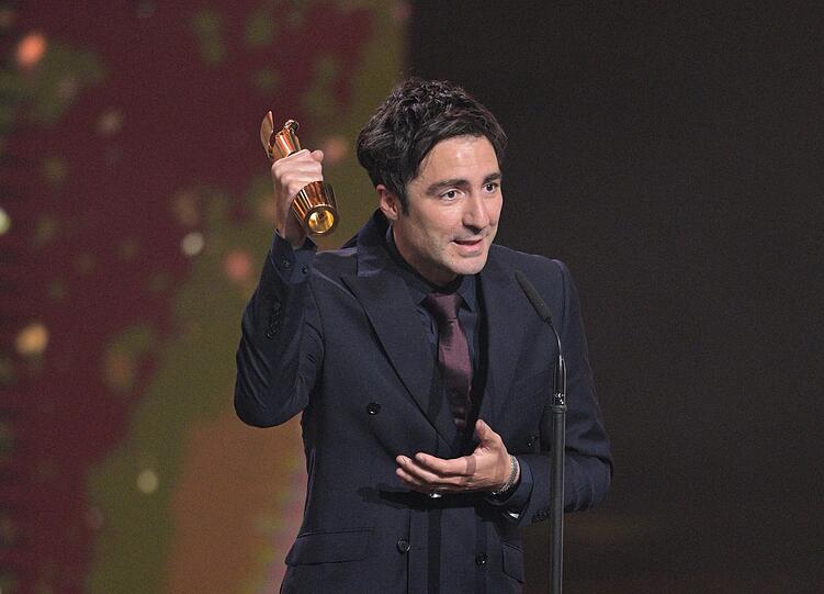 Regisseur Ilker Catak, bei der Verleihung des Deutschen Filmpreises mit dem Preis f&uuml;r die beste Regie f&uuml;r &bdquo;Das Lehrerzimmer&ldquo;. Ebenfalls eine Produktion von Ingo Fliess.