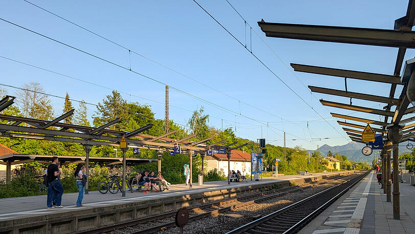 An den Bahnsteigen in Prien lässt die Bundesbahn ihre wartenden Fahrgäste im Regen stehen,