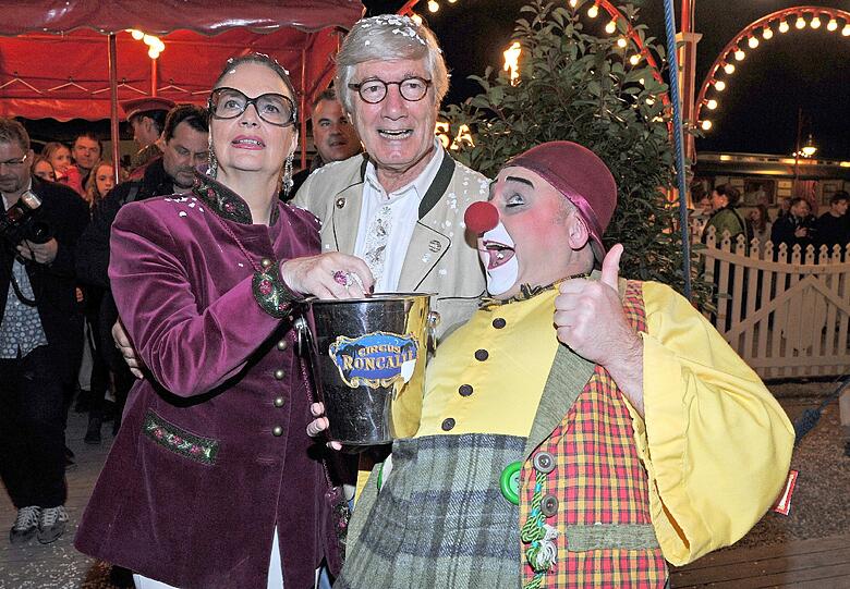 Clown Eddy begrüßt den Schauspieler Christian Wolff und seine Frau Marina zur Gala-Premiere von Circus Roncalli.