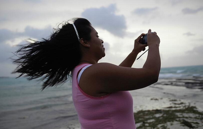 Diese Dame auf den Bahamas lässt sich von der herannahenden Sturmfront nicht einschüchtern. Sie schießt ein Foto vom Wirbelsturm.