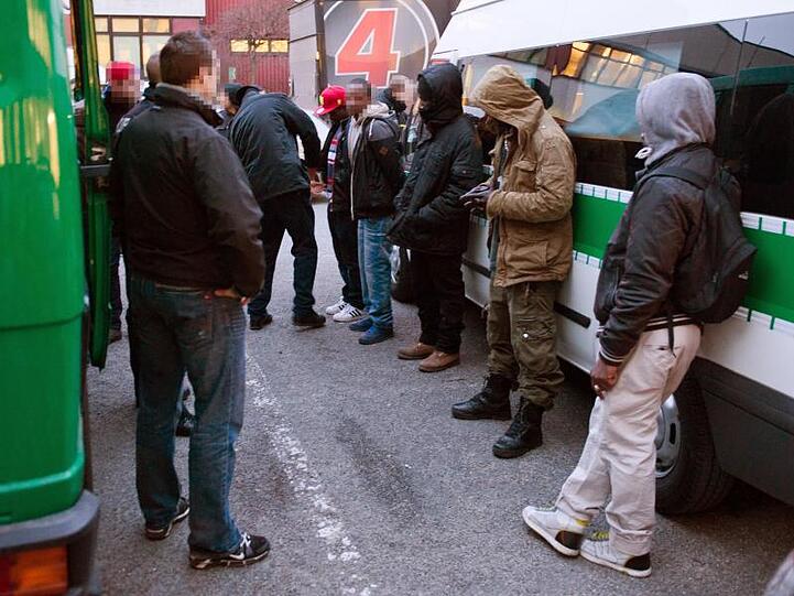 Drogen-Razzia im Görlitzer Park in Berlin: Vorläufig festgenommene, mutmaßliche Drogenhändler stehen vor einem Polizeiwagen.