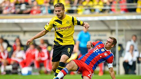 Im Supercup verloren die Bayern gegen Dortmund: Die beiden WM-Fahrer Ciro Immobile und Philipp Lahm.