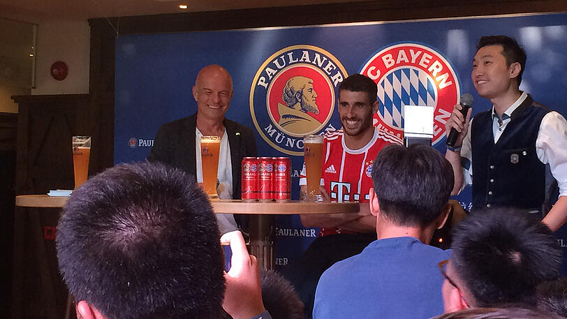 Bayern-Star Javi Martínez feiert mit den Fans im Paulaner Bräuhaus in Shanghai.