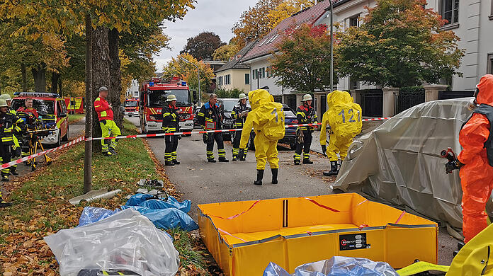 Feuerwehrleute in speziellen Schutzanz&uuml;gen sind im Einsatz.