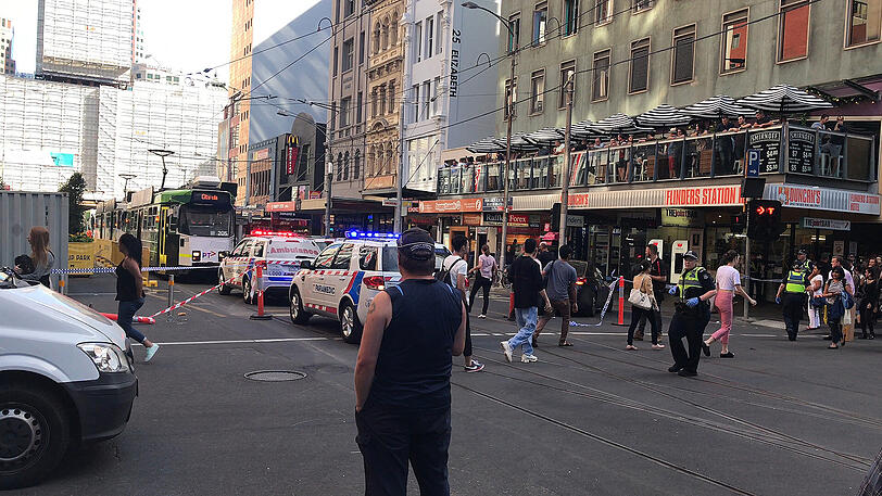 Polizei- und Rettungswagen stehen in der Flinders Street in Melbourne.