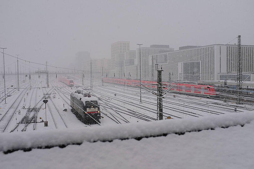 Nebelige Sicht von der Hackerbr&uuml;cke: Die Gleise sind stark eingschneit, die B&uuml;rogeb&auml;ude am Arnulfpark sind kaum zu erkennen.