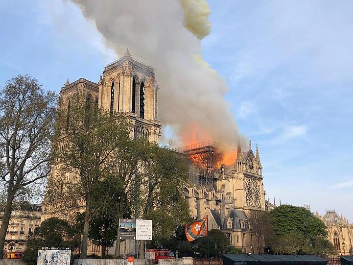 Flammen und Rauch steigen von einem der berühmtesten Wahrzeichen der Welt, der Pariser Kathedrale Notre-Dame, auf.