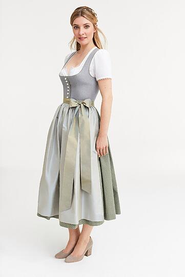 Dirndl mit traditionellen Elementen wie stilvollen Naturtönen, einem edlen Leinenmieder mit Kontrast-Paspeln und einer dezenten Perlen-Knopfleiste setzen Sie auch 2017 gekonnt in Szene