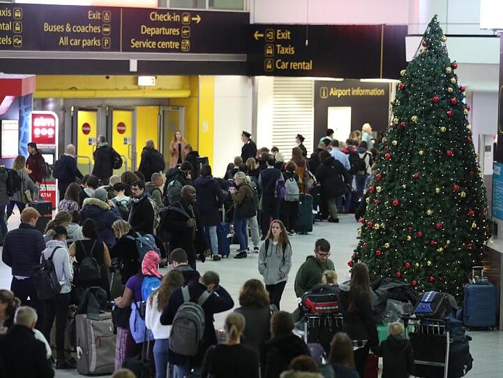 Passagiere am Flughafen Gatwick warten auf ihre Flüge nach den Verspätungen und Annullierungen, die durch Drohnensichtungen verursacht wurden.