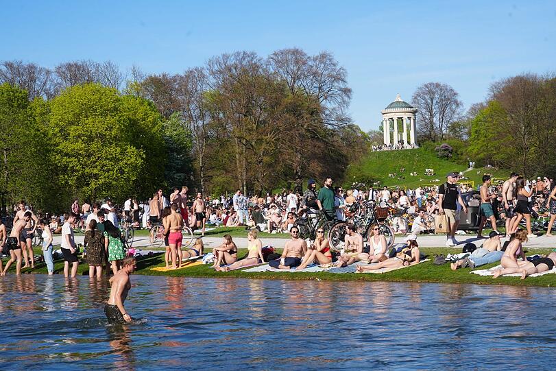 Der Schwabinger Bach im Englischen Garten bietet sich am Wochenende perfekt für eine Erfrischung an. Dementsprechend voll ist es am Ufer.