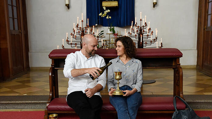 Pfarrer Reiser (Stephan Zinner) und Lisa (Anne Schäfer) trinken Wein und reden.