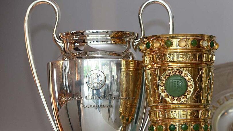 Objekte der Begierde: Der Champions-League-Pott und der DFB-Pokal. Objekte der Begierde: Der Champions-League-Pott und der DFB-Pokal.