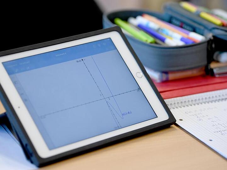 Ein Schüler eines Gymnasiuma errechnet eine Gleichung mit einem iPad im Matheunterricht. Foto: Britta Pedersen/Archiv