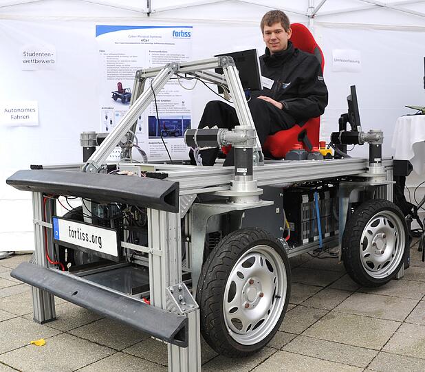 Nicht schön, aber zukunftsweisend: Zugegeben: Einen Designpreis wird dieses Gerät vermutlich nicht bekommen. Aber seine Fähigkeiten haben auch gar nichts mit gutem Aussehen zu tun: Das eCar ist eine Plattform, mit der die Forscher etwa in Sachen Rechnerleistung und -anordnung experimentieren. Jedes Rad wird über einen eigenen kleinen Computer gesteuert, nicht alle vier von einem großen. eCar soll Aufschlüsse über den zukünftigen Einsatz von Elektrik, Elektronik und Software liefern. Dank seiner Feinsteuerung eignet er sich zum Beispiel ideal für den Einsatz in Regalhallen oder Fabrikanlagen.