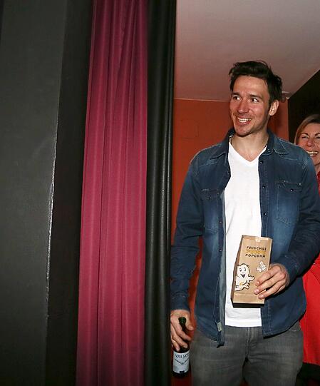 Da isser! Felix betritt lässig mit einer Tüte Popcorn und einem Getränk den Saal.