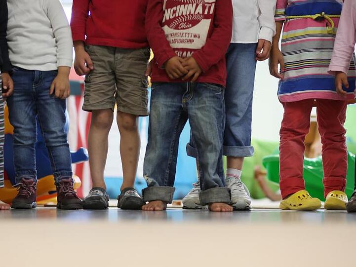 Kinder stehen im Rahmen eines Medientermins in einem Kindergarten.