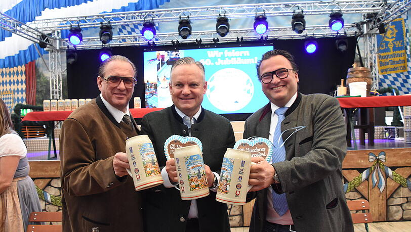 Hier pr&auml;sentiert Wirtschaftsreferent Christian Scharpf (M., SPD) zusammen mit den Schaustellern Robert Eckl (l.) und Peter Bausch stolz den KI-Krug.