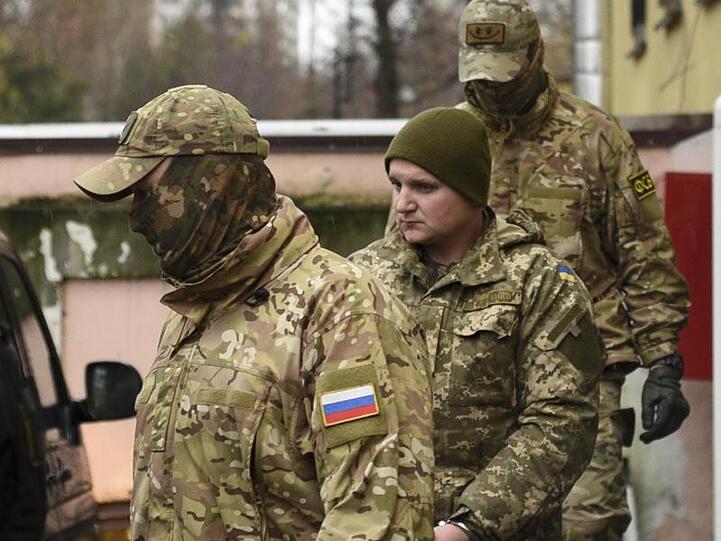 Ein ukrainischer Matrose (2.v.r.) wird von russischen Polizisten aus einem Gericht in Simferopol geleitet.