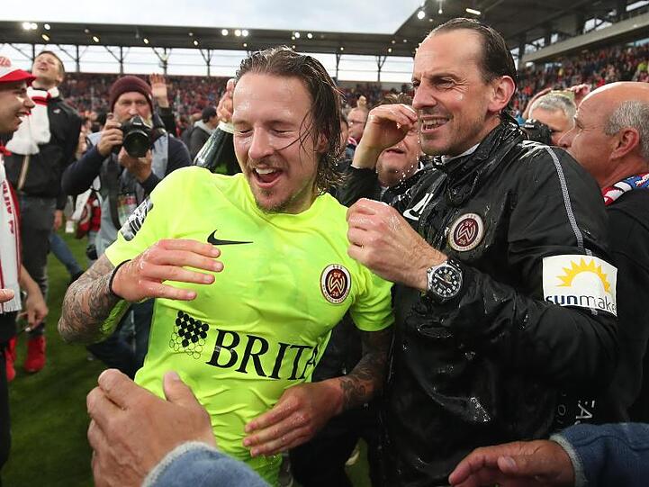 Wiesbadens Moritz Kuhn (l) jubelt mit seinem Trainer Rüdiger Rehm über den Aufstieg in die 2. Bundesliga.