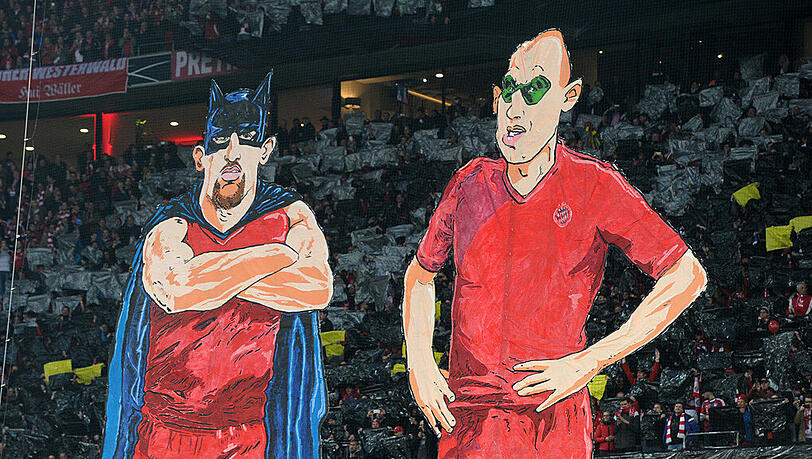 In einer Fan-Choreographie werden Darstellungen von Franck Ribery (l) und Arjen Robben als Badman (Batman) & Robben (Robin) gezeigt. Auf das reale Duo "Rib und Rob" muss der FC Bayern am Samstag gegen Ingolstadt verzichten. In einer Fan-Choreographie werden Darstellungen von Franck Ribery (l) und Arjen Robben als Badman (Batman) & Robben (Robin) gezeigt. Auf das reale Duo "Rib und Rob" muss der FC Bayern am Samstag gegen Ingolstadt verzichten.