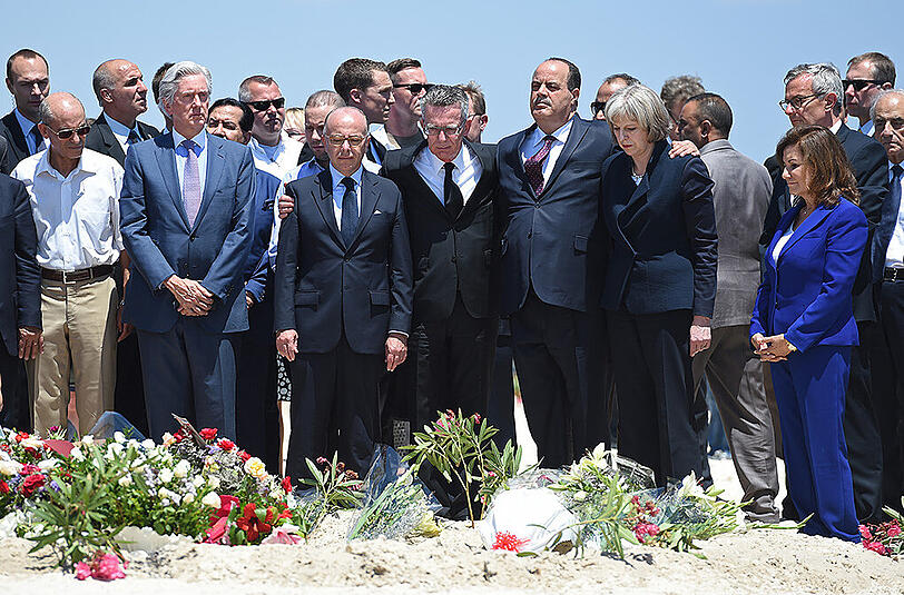 Hotelbesitzerin Zohra Driss (r-l), die britische Innenministerin Theresa May, der tunesische Innenminister Mohamed Najem Gharsalli, Bundesinnenminister Thomas de Maiziere (CDU) und der französische Innenminister Bernard Cazeneuve besuchen den Tatort am Strand vor dem Imperial Marhaba Hotel in Sousse.
