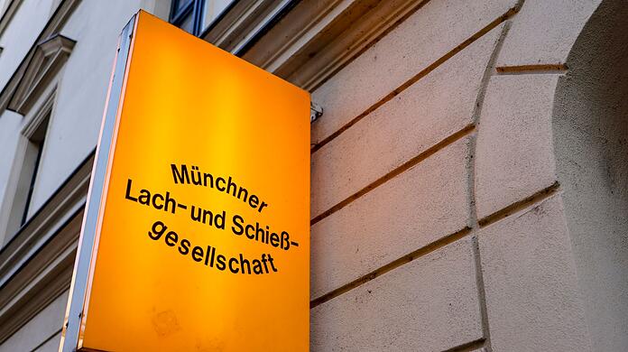 Ein beleuchtetest Schild markiert den Eingang zur Lach- und Schießgesellschaft.