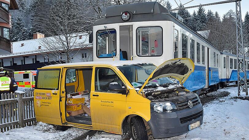 Das Postauto steht nach dem Unfall auf den Schienen vor einem Zug der Bayerischen Zugspitzbahn. Das Postauto steht nach dem Unfall auf den Schienen vor einem Zug der Bayerischen Zugspitzbahn.
