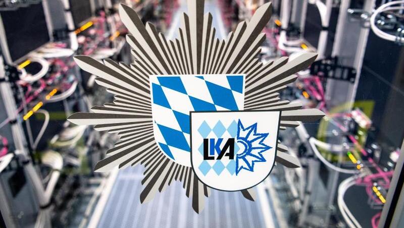 Das Logo vom bayerischen Landeskriminalamt ist an der Tür zu einem Serverraum zu sehen.