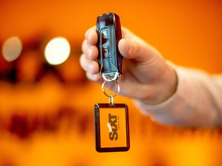 Bei dem Mietwagenanbieter Sixt wird ein Autoschlüssel überreicht. Foto: Sina Schuldt/dpa/Archivbild