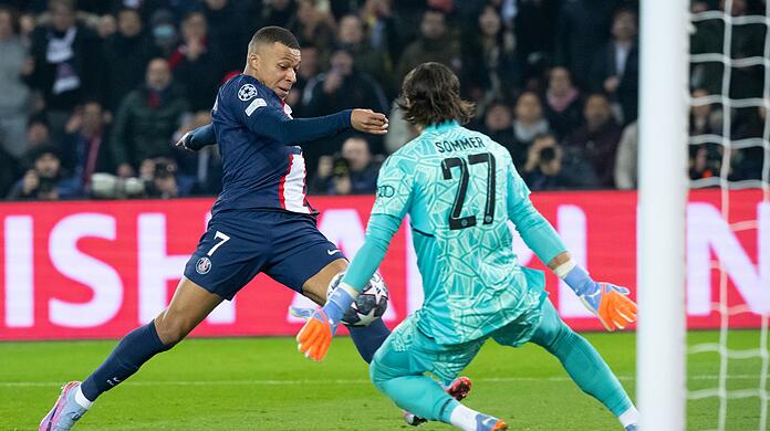 Kylian Mbappe (l) von Paris und Torwart Yann Sommer von München kämpfen um den Ball.