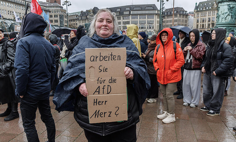 Eine Frau hält auf einer Demonstration unter dem Motto "Wir sind das Stadtbild" ein Schild mit der Aufschrift "Arbeiten Sie für die AfD Herr Merz?". Der Protest richtete sich gegen Aussagen von Bundeskanzler Merz zu Stadtbild und Migration. Eine Frau hält auf einer Demonstration unter dem Motto "Wir sind das Stadtbild" ein Schild mit der Aufschrift "Arbeiten Sie für die AfD Herr Merz?". Der Protest richtete sich gegen Aussagen von Bundeskanzler Merz zu Stadtbild und Migration.