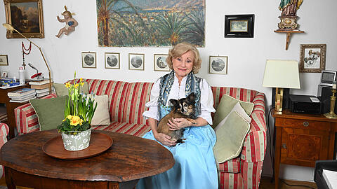 Ein Herz und eine Seele: Margot Hellwig zeigt mit Hund Gustl auf dem Arm ihr Zuhause