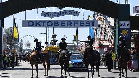 Berittene Polizisten stehen nach dem Einzug der Wiesnwirte zum Oktoberfest vor dem Eingang. Foto: Angelika Warmuth