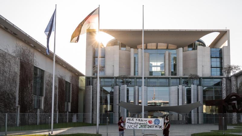 Zwei Demonstranten stehen bei einer Protestaktion gegen die Anschaffung neuer Kampfflugzeuge durch die Bundesregierung vor dem Kanzleramt. Zwei Demonstranten stehen bei einer Protestaktion gegen die Anschaffung neuer Kampfflugzeuge durch die Bundesregierung vor dem Kanzleramt.