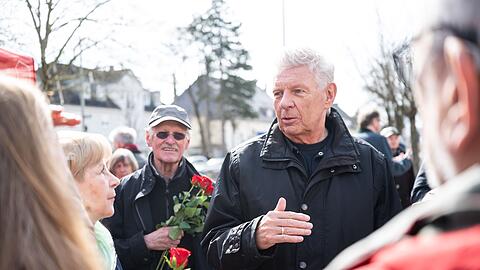 Reiter verteilt bei seinen Auftritten Blumen in SPD-Rot.