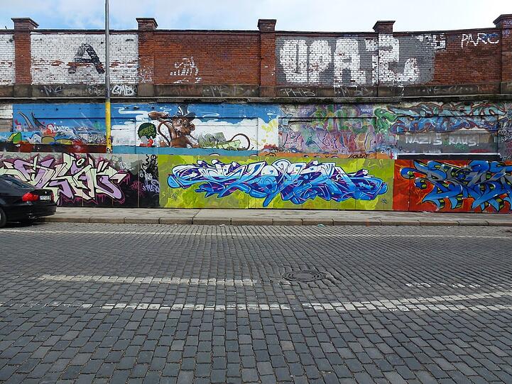 Die Ziegelwand an der Thalkirchner Straße haben Graffiti-Sprayer längst in Beschlag genommen. Jetzt sollen sie Bauzäune offiziell besprühen dürfen.