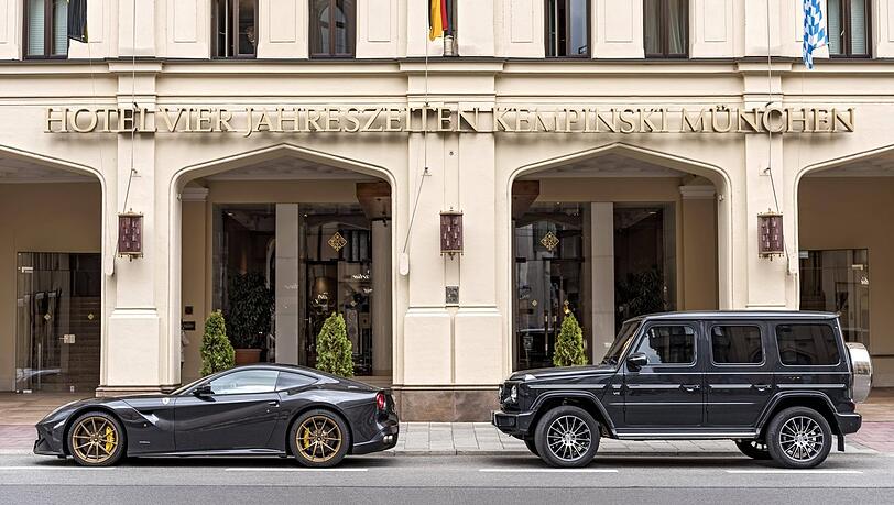 Ein Ferrari und ein Mercedes parken vor dem Hotel Vier Jahreszeiten. Für den Besitzer des SUV könnte es in Zukunft deutlich teurer werden, sein Fahrzeug in der Innenstadt abzustellen - vorausgesetzt, die Deutsche Umwelthilfe hat mit ihrem Antrag Erfolg.