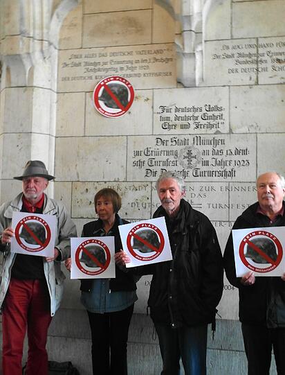Mitglieder des Münchner Friedensbündnis vor der Gedenktafel