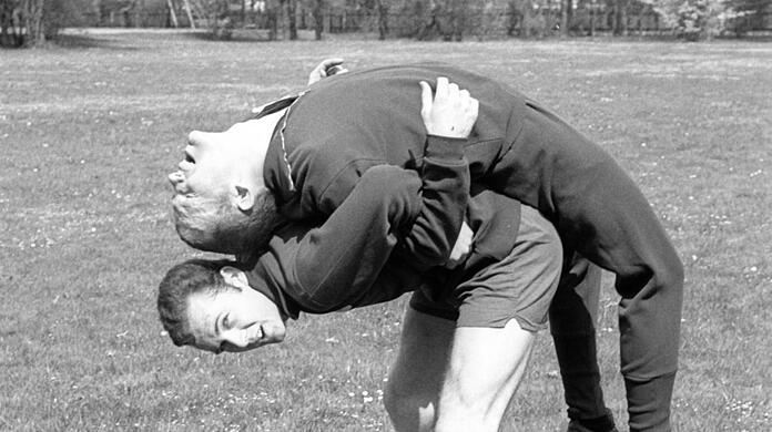Dehnen mit dem Kaiser: Franz Beckenbauer und Peter Kupferschmidt (oben) bei Aufwärmübungen.
