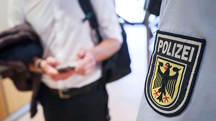 Ein Beamter der Bundespolizei kontrolliert einen Mann.