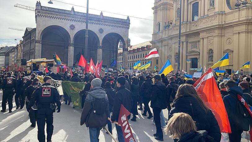Als die "Demo Schreer" den Odeonsplatz mit seiner "Ukraine-Demo" in Höhe der Feldherrnhalle passiert, wird es kurz sehr eng und sehr laut.
