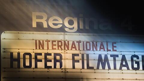 Auf einer Tafel ist die Aufschrift "Internationale Hofer Filmtage" zu lesen (Langzeitbelichtung). Foto: Nicolas Armer/dpa/Archivbild