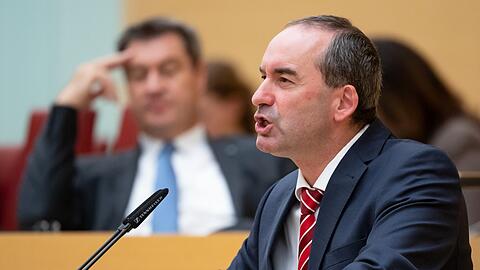 Markus Söder (CSU, Hintergrund) wirkt während Aiwangers (FW) Rede eher gelangweilt.
