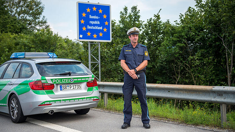 Ein Beamter der bayerischen Grenzpolizei steht am Grenzübergang Kirchdorf an der deutschen Staatsgrenze.