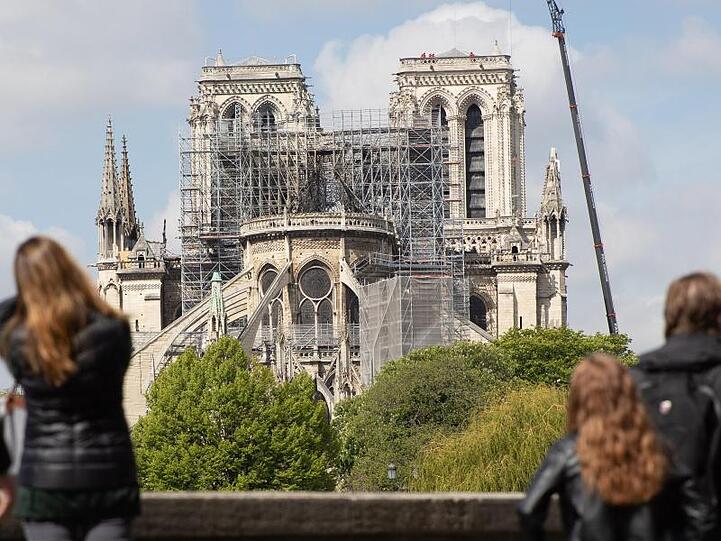Ein Baukran steht neben der Pariser Kathedrale Notre-Dame. Das Feuer vom 15. April hat die Kathedrale stark zerstört.