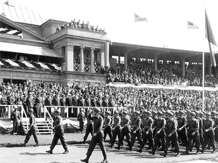 Der scheidende Nato-Oberbefehlshaber General Dwight D. Eisenhower (an der Tribünentreppe rechts) nimmt im April 1952 im Frankfurter Stadion eine Parade von 4000 US-Soldaten ab.