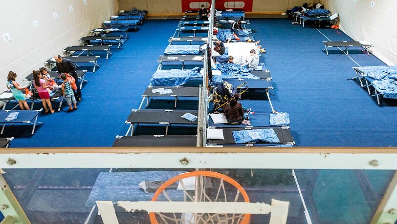 Flüchtlinge in einer Turnhalle (Archivbild). Flüchtlinge in einer Turnhalle (Archivbild).