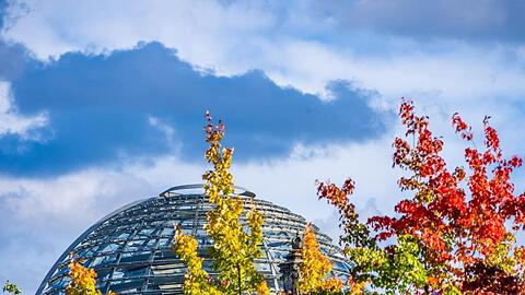 Die Kuppel auf dem Deutschen Bundestag hinter bunt gefärbten Laubbäumen. In den kommenden Tagen finden zahlreiche Gespräche über die Bildung der künftigen Regierung statt.